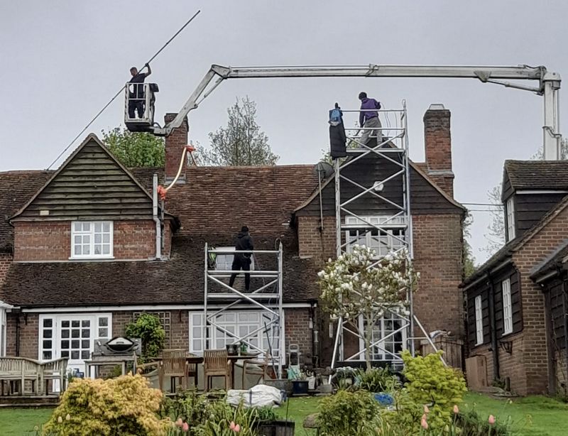 The Roof Moss Cleaners using cherry picker and scaffolding to clean roof safely and professionally in Ramsey, Cambridgeshire