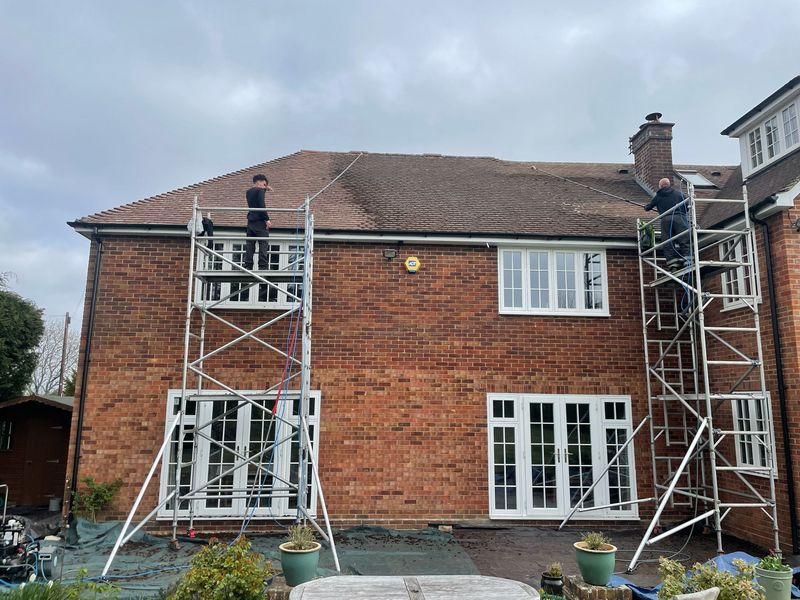 Roof cleaning carried out safely from scaffold towers by The Roof Moss Cleaners in Ramsey